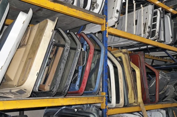 Old car doors on shelves in a scrapyard — Stock Photo, Image