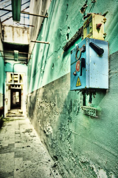 Old electrical fittings in derelict corridor of a former coal mi — Stock Photo, Image