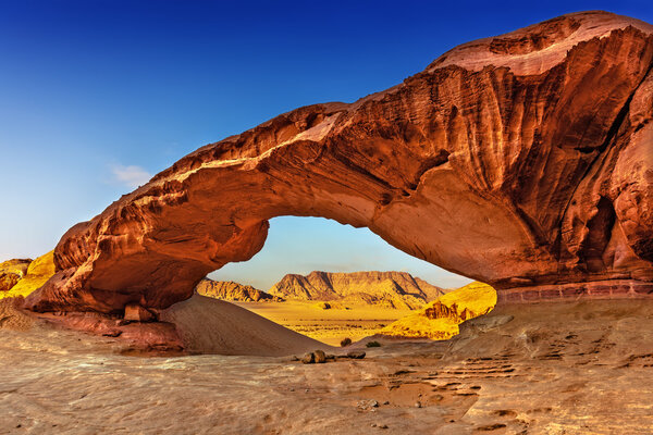 View through a rock arch in the desert of Wadi Rum