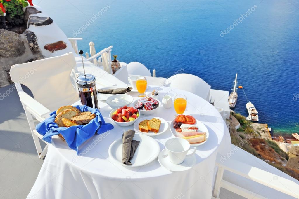 Breakfast on a terrace overlooking the sea in Oia