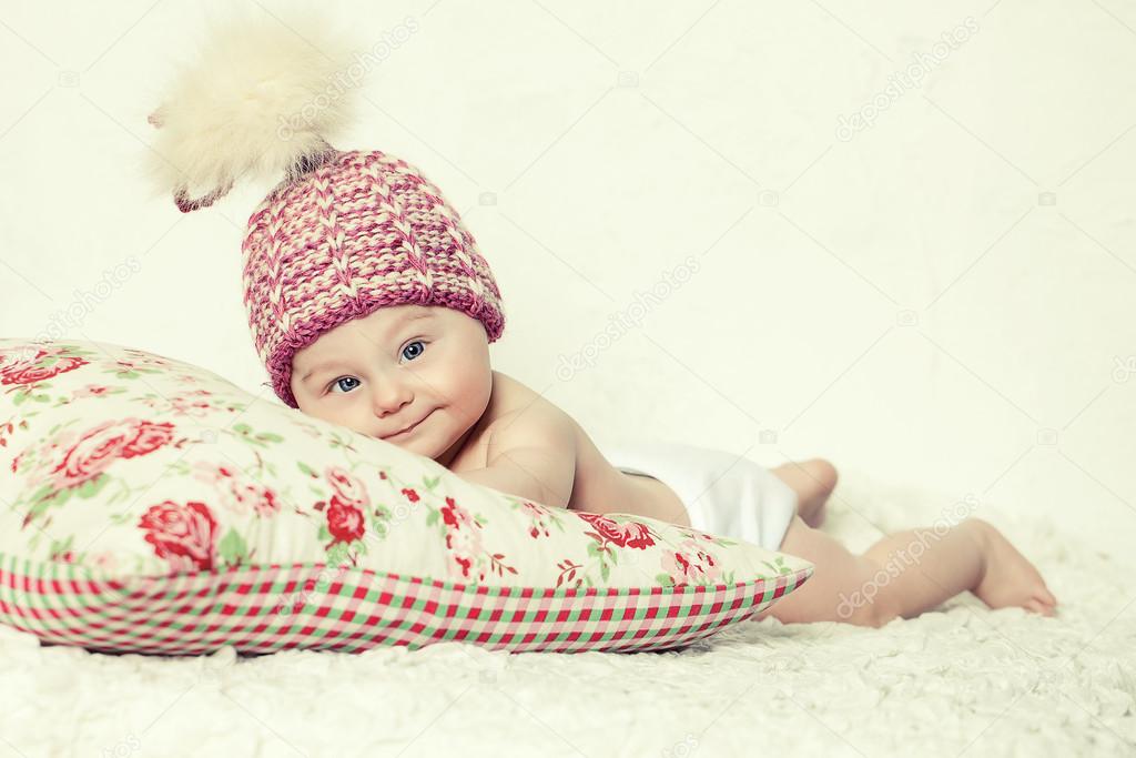 Smiling baby in pink hat