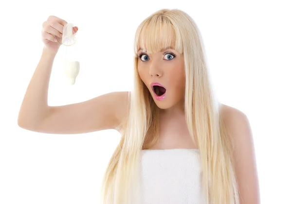 Surprised woman holding condom — Stock Photo, Image