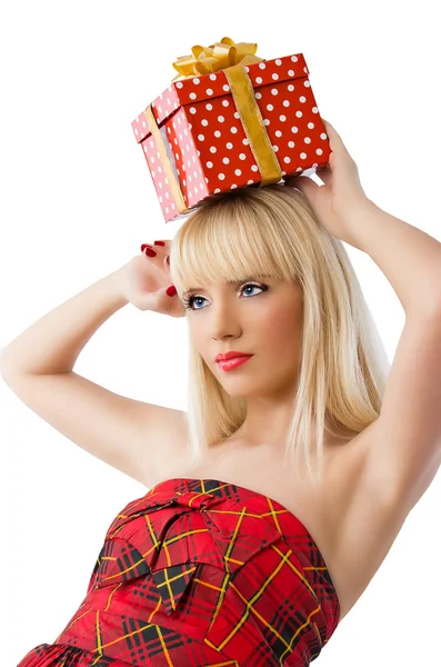 Beautiful blonde girl holding christmas gift in red dress — Stock Photo, Image