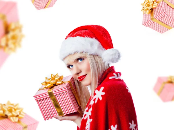 Beautiful blonde woman holding christmas gift in red hat — Stock Photo, Image