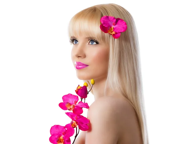 Beautiful blonde young girl with orchid flowers — Stock Photo, Image