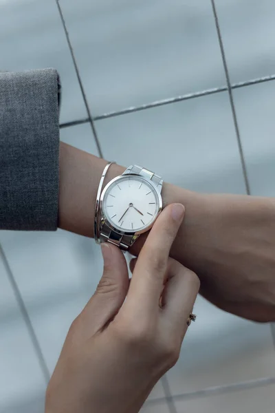 Stylish white watch on woman hand
