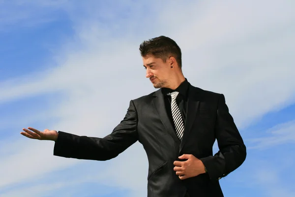 Business man offering an object — Stock Photo, Image