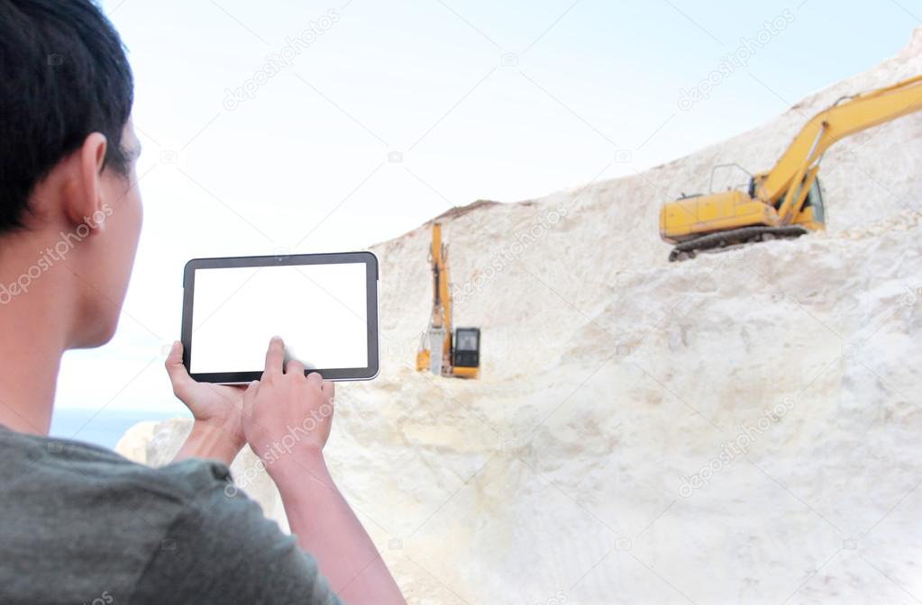 Architect with tablet pc planning on building something