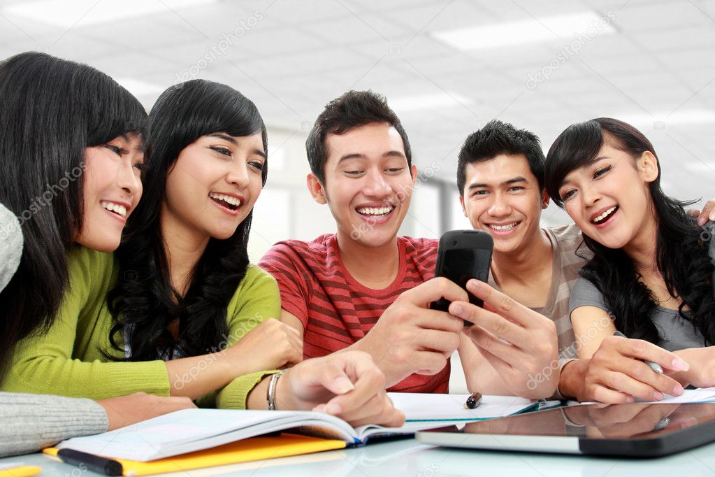 Group of students using mobile phone