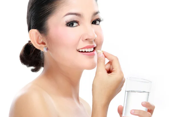 Woman taking vitamin tablet — Stock Photo, Image