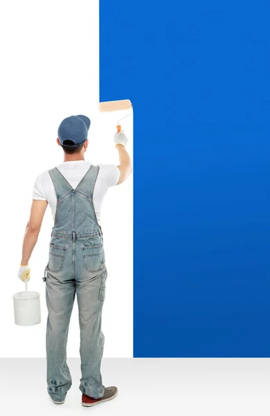 Painter painting some walls with blue paint — Stock Photo, Image