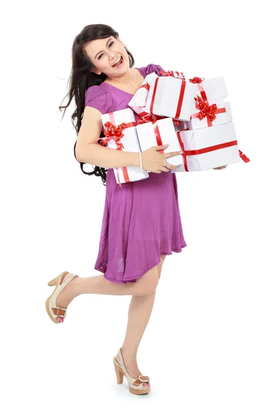 Happy woman carrying lots of presents — Stockfoto