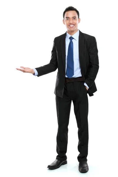 Smiling asian business man presenting a blank space Stock Photo