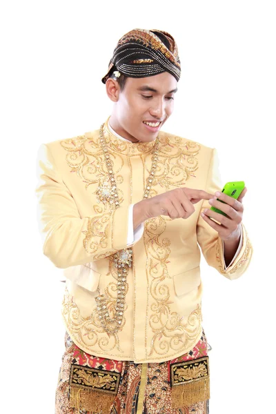 Man with traditional java suit using mobile phone — Stock Photo, Image