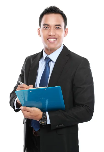 Businessman takes notes on clipboard — Stock Photo, Image