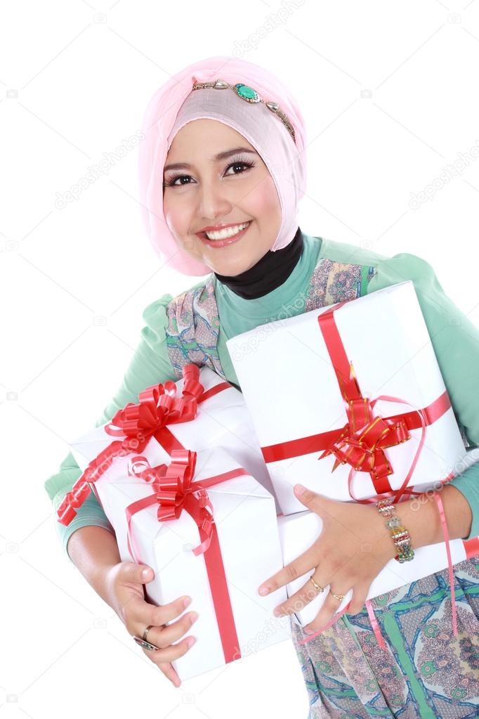 Happy young muslim woman with gift boxes