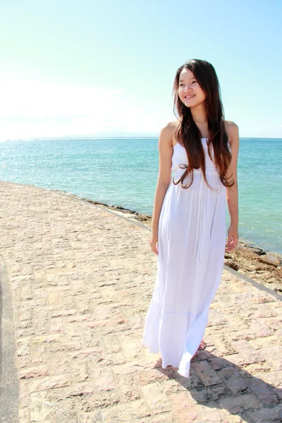 Beautiful woman standing on sand and looking at the camera — Stock Photo, Image