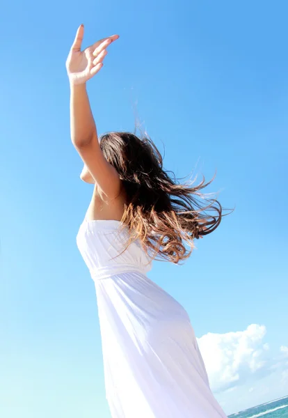 Woman relaxing at the beach with arms open enjoying her freedom — Stock Photo, Image