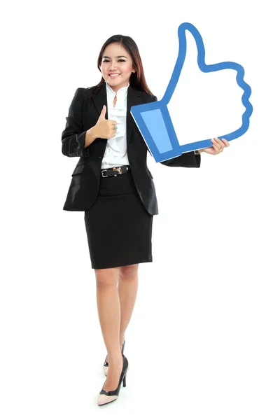 Businesswoman holding like sign — Stock Photo, Image