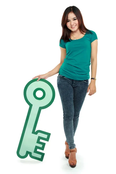 Woman holding key sign — Stock Photo, Image