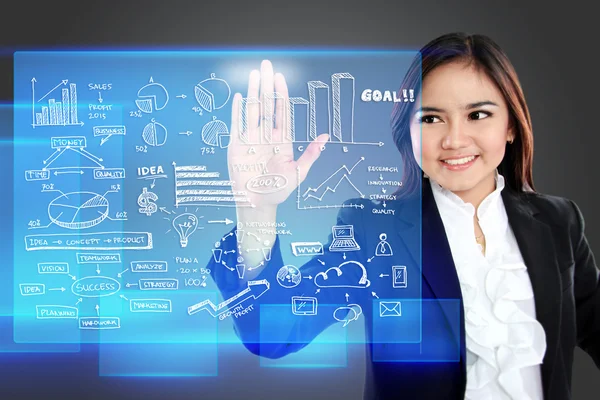 Geschäftsfrau zeigt auf eine Grafik auf transparentem Touchscreen — Stockfoto