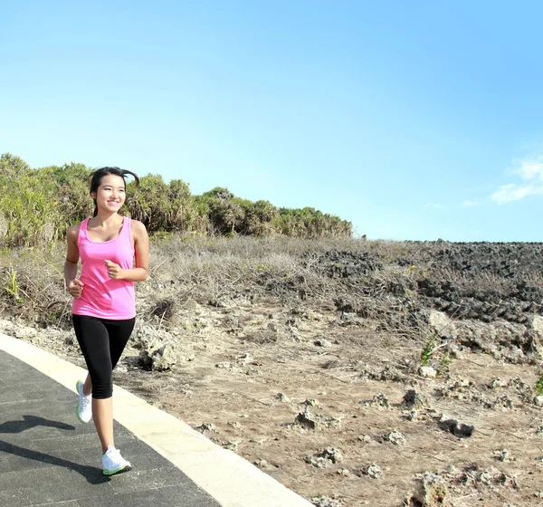 Beautiful girl jogging on jogging track — Stock Photo, Image