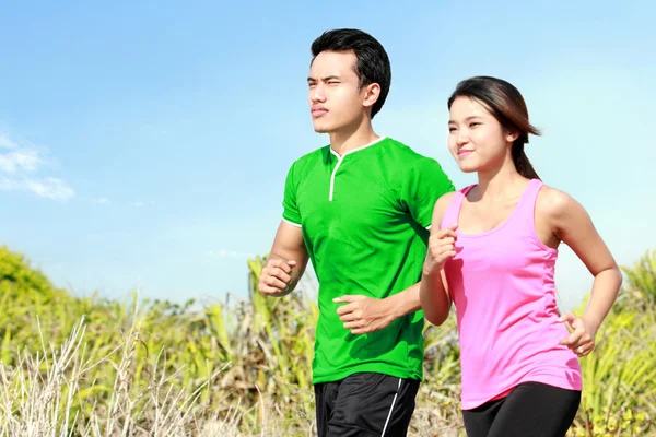 Young couple running together — Stock Photo, Image