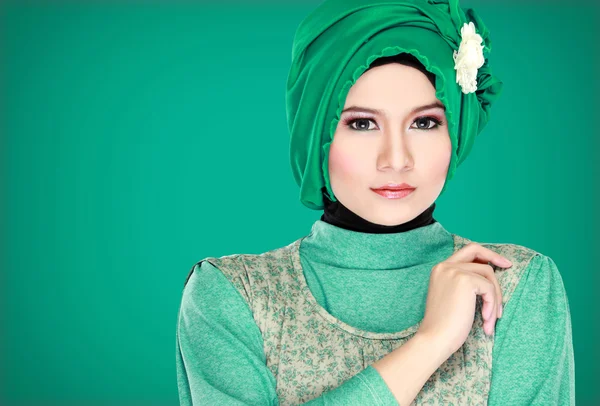 Fashion portrait of young beautiful muslim woman with green cost — Stock Photo, Image