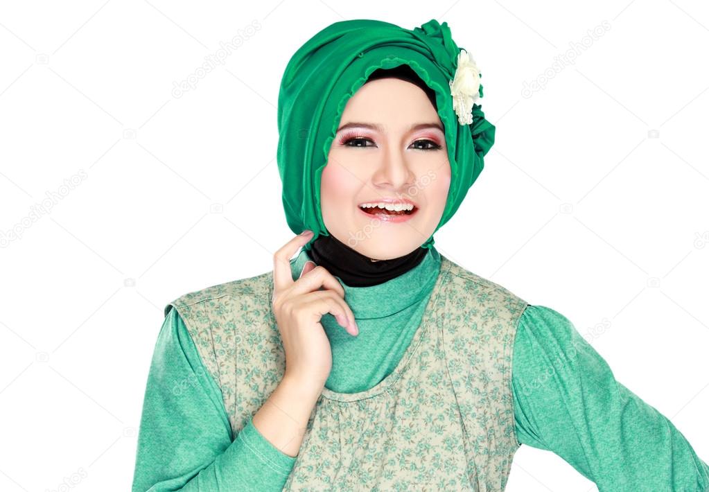 Fashion portrait of young happy beautiful muslim woman with gree