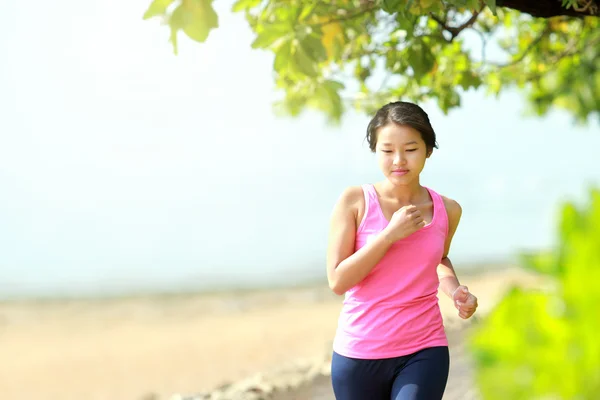 Mooi meisje joggen op het strand — Stockfoto