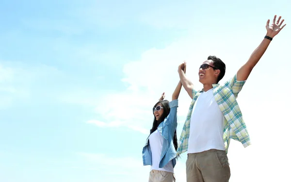 Portrait of young couple standing and raised their hands — Stock Photo, Image