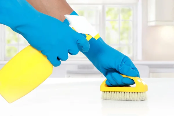 Hand with glove using cleaning brush to clean up — Stock Photo, Image