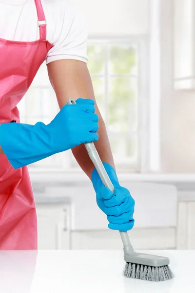 Hand with glove using cleaning brush to clean up — Stock Photo, Image