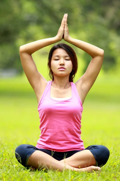 Flickan gör meditation på stranden — Stockfoto