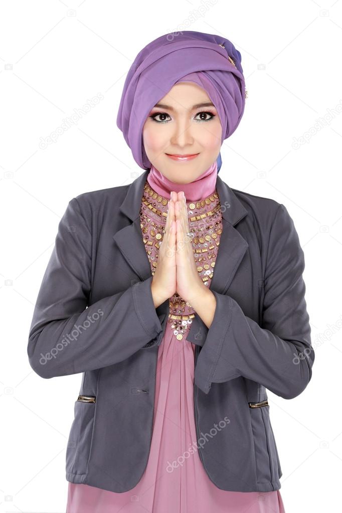Beautiful welcoming girl wearing hijab smiling