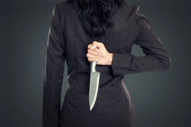 Business woman Holding Knife Behind His Back clipart