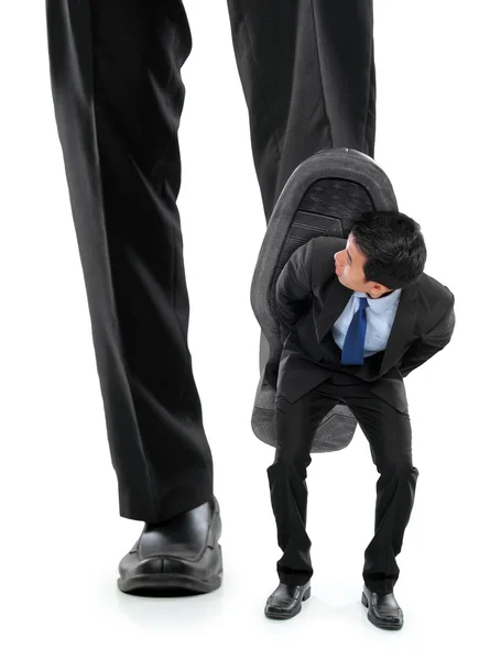Pequeno homem de negócios a ser esmagado pelos pés — Fotografia de Stock