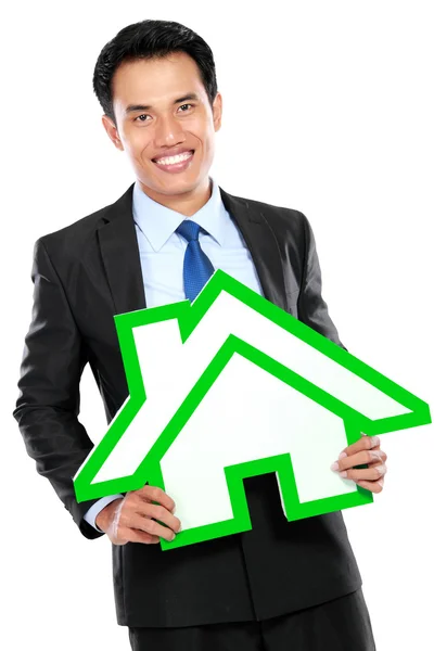 Portrait of businessman holding house sign — Stock Photo, Image