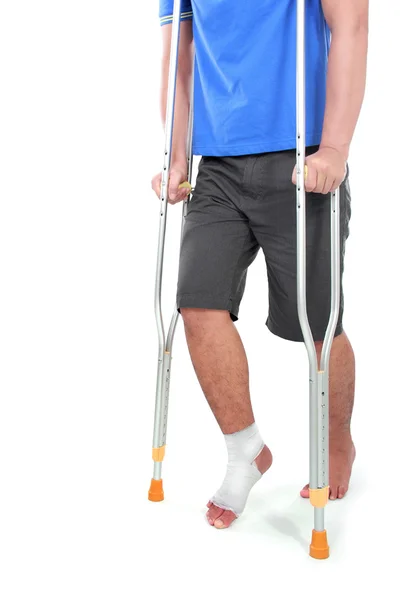 Portrait of a broken foot using crutch — Stock Photo, Image