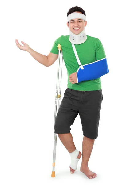 Male with broken arm and crutch presenting — Stock Photo, Image