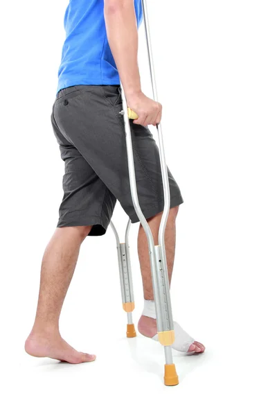 Portrait of a broken foot using crutch — Stock Photo, Image