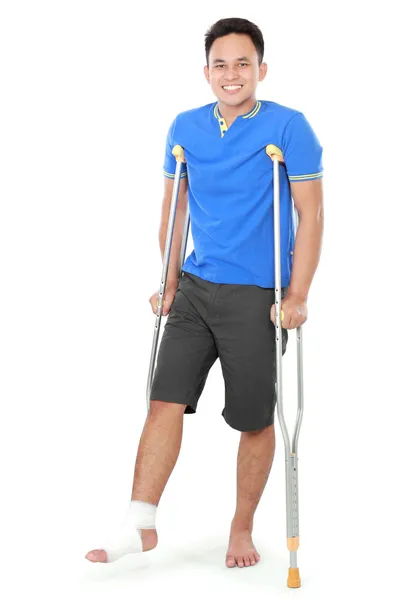 Macho com pé quebrado usando muleta — Fotografia de Stock