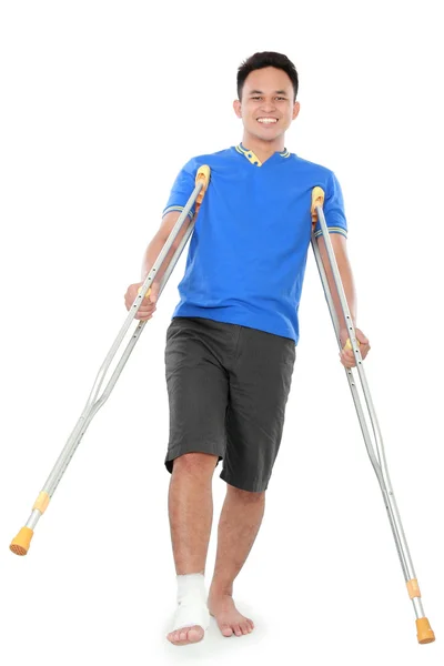 Male with broken foot using crutch — Stockfoto