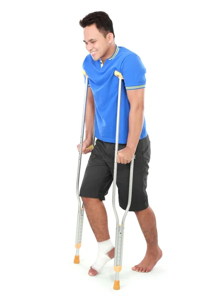 Male with broken foot using crutch — Stock Photo, Image