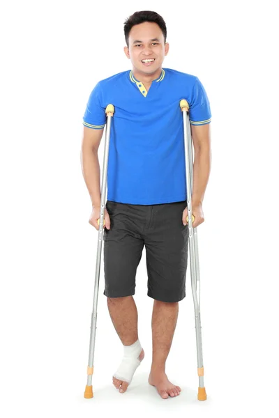 Male with broken foot using crutch — Zdjęcie stockowe