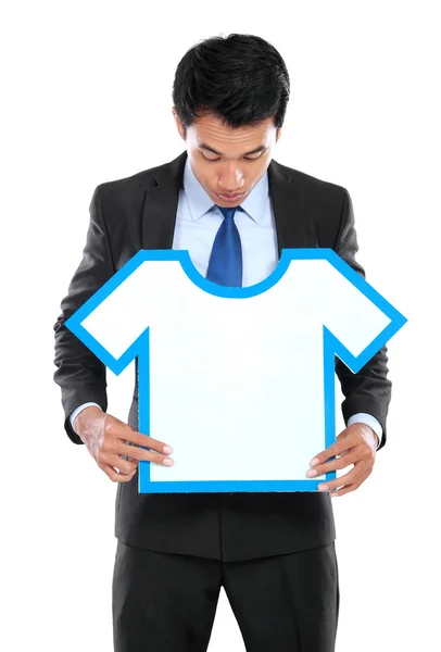 Young businessman holding shirt sign — Stock Photo, Image