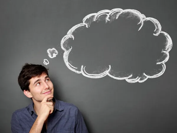 Happy young man looking up to bubble — Stock Photo, Image