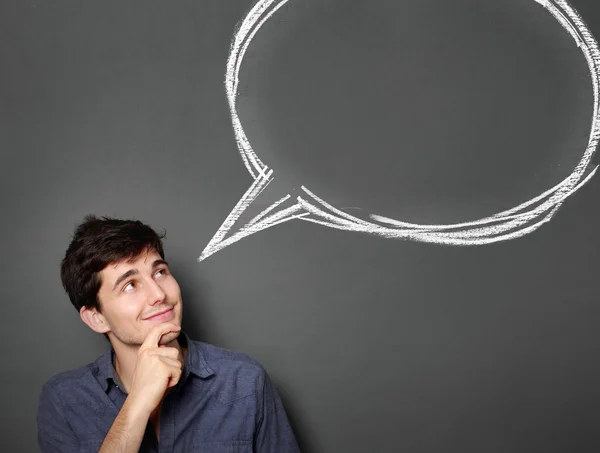 Happy young man looking up to blank bubble text — Stock Photo, Image