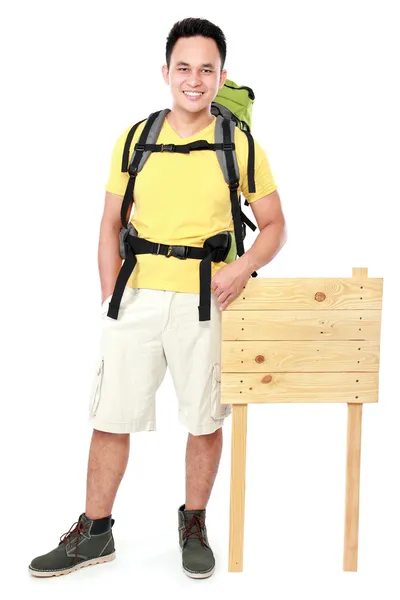 Hiker man tourist with blank wood sign — Stock Photo, Image