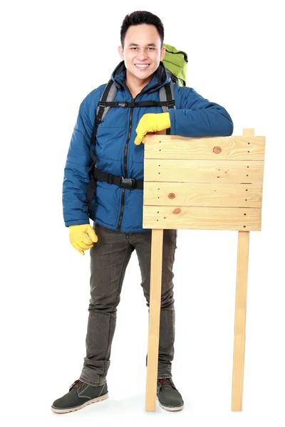 Hiker man tourist with blank wood sign — Stock Photo, Image